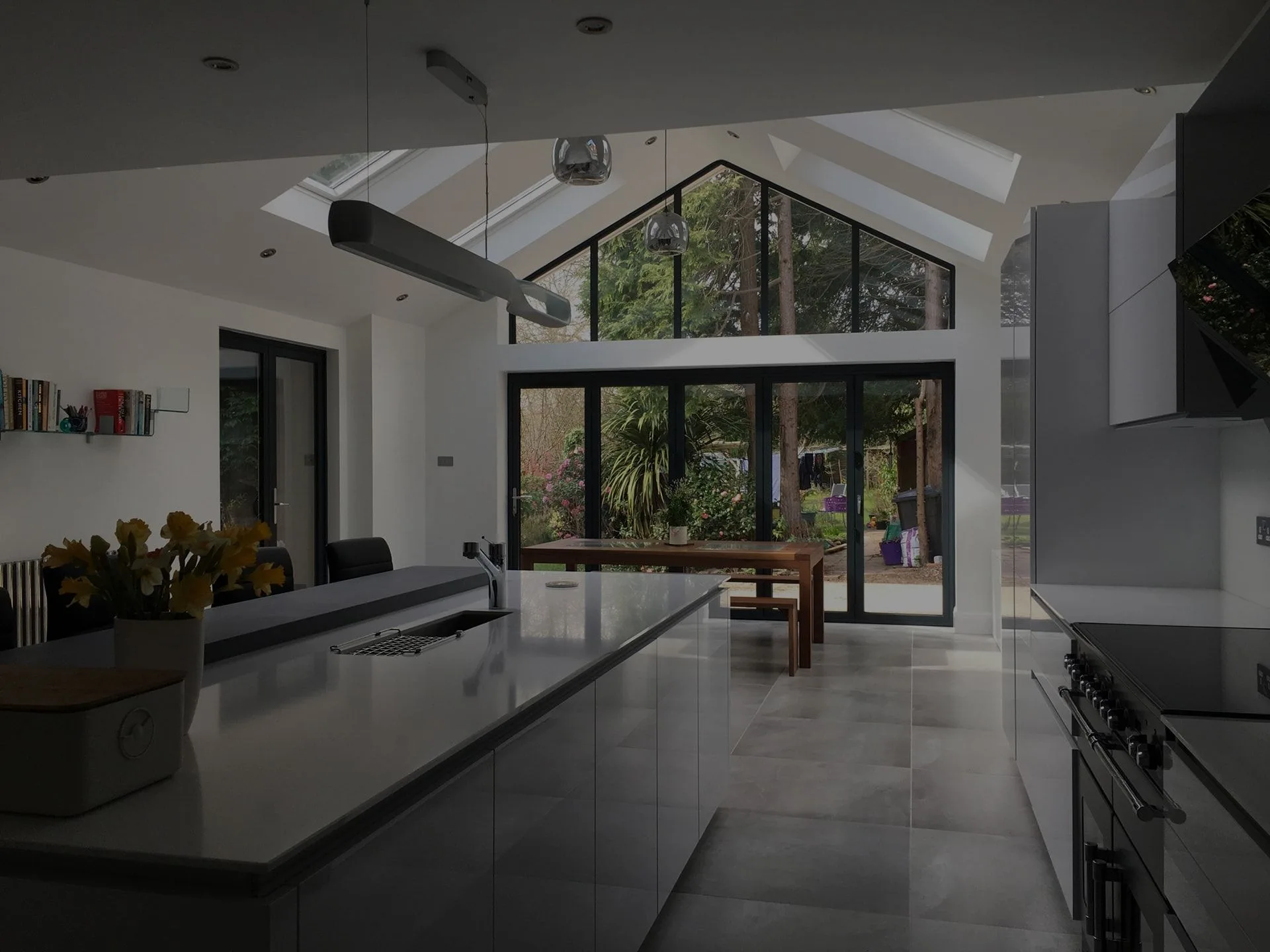 Kitchen extension with a long island and full-height gable glazing