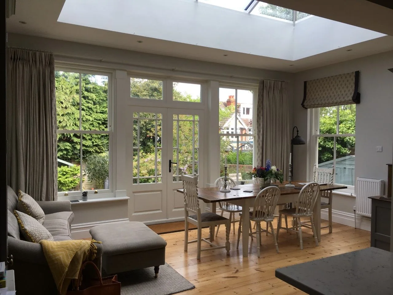Open-plan living and dining room under a glazed roof lantern